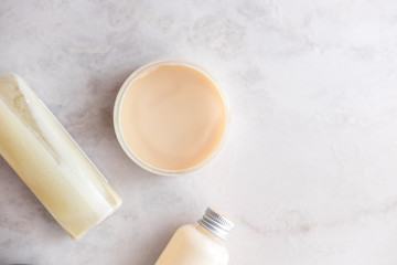 Spa cosmetics on white marble background from above. Beauty blogging concept. Copyspace