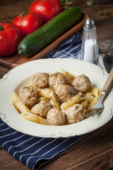 Pork meatballs with dill sauce and pasta. Selective focus.
