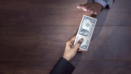 Businessman refusing money offered by a man