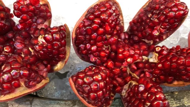 Closeup of red ripe juicy pomegranate is beautiful casing on ice