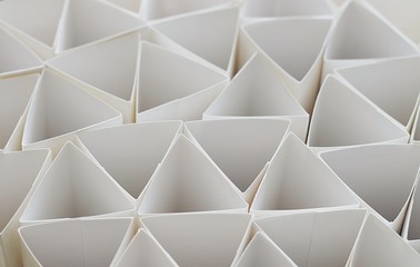 Macro photo of geometric shapes of paper in black and white, three-dimensional triangles, abstract background