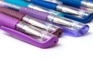 closeup of colorful ballpoint pens on white background