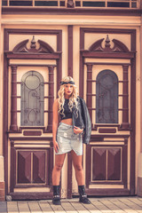 Obraz premium Stylized girl posing near old wooden door