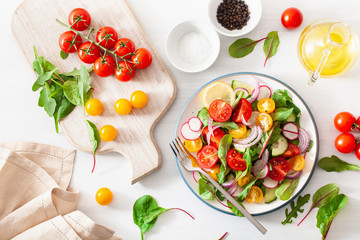healthy colorful vegan tomato salad with cucumber, radish, onion