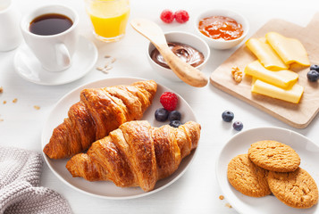 Continental breakfast with croissant,  jam, chocolate spread and coffee