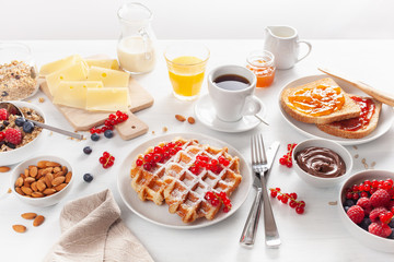 breakfast with granola berry nuts, waffle, toast,  jam, chocolate spread and coffee