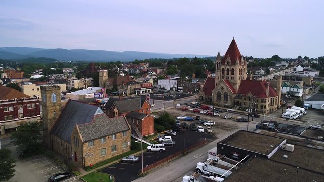A slowly rising forward moving aerial establishing shot of the small town of Uniontown, Pennsylvania, about 40 miles outside of Pittsburgh.  	