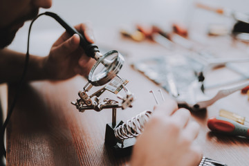 Close up Young Man Repairing Mobile Phone at Table