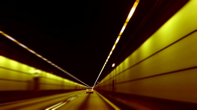 Roadtunnel outside of Copenhagen, Denmark. Timelapse. Car driving fast through tunnel.