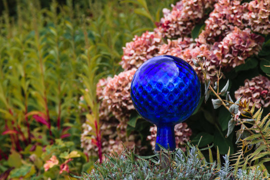 Blue decorative glass globe in the garden