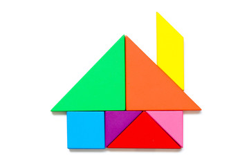 Color wood tangram puzzle in home shape on white background