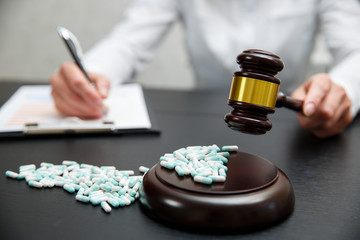 Medicine law concept. Judges gavel with pills