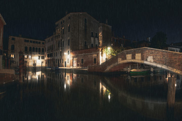 Fototapeta premium empty street along water channel in Venice by rainy night
