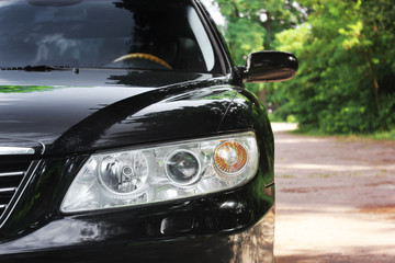 Car lanterns. Luxury headlights of a black car