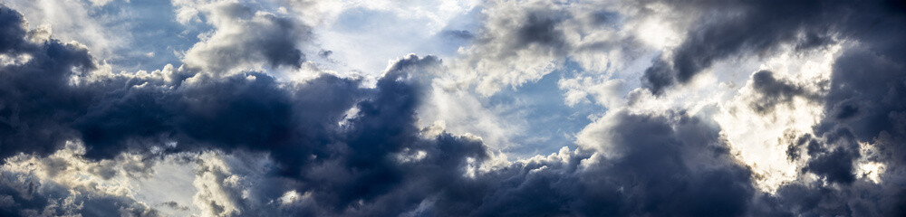 Obraz premium the panoramic view on blue sky with dramatic clouds