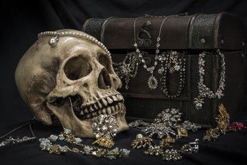 Still life with a human skull with old treasure chest and gold, diamond
