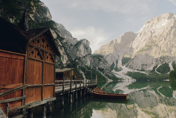 Beautiful wooden house by the lake somewhere in Italian Dolomites