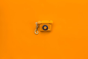 retro orange phone isolated on orange background