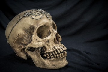 Still life with a human skull with the old, in with the diamond and jewelry