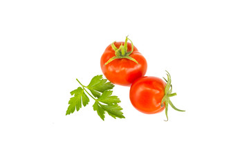 Two fresh juicy red cherry tomatoes with green parsley leaf, organic food ingredient, close up, isolated on white
