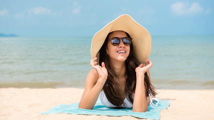 Happy woman relaxing at the beach in summer