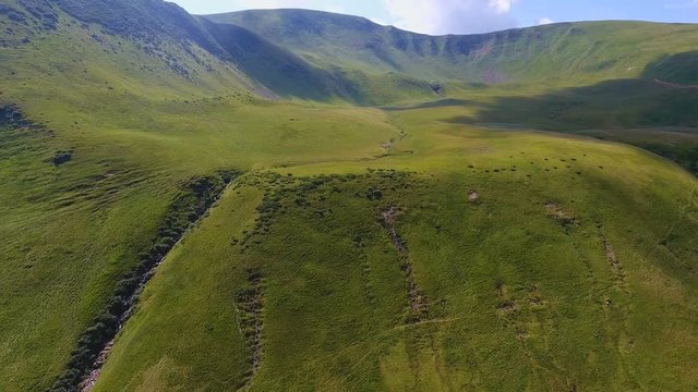 Aerial of a half-round ravine with sharp slopes and gorges in the Carpathians