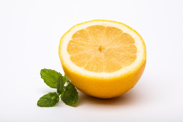 Half a lemon with mint on the side isolated on a white background
