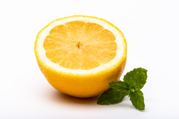 Half a lemon with mint on the side isolated on a white background
