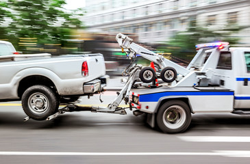 tow truck delivers the damaged vehicle