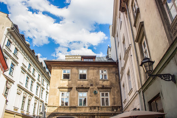 old poor european buildings facade in backstreet slum city district with corner narrow shape street 