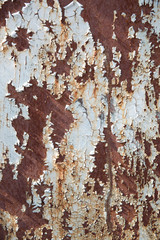 The texture of a rusty iron and a blue strongly peeling paint