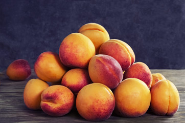 Ripe fresh apricots on a wooden background,