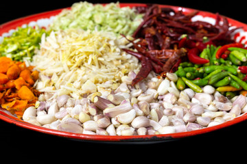 Garlic and thai herb ingredients of Thai red curry paste recipe in a tray.
