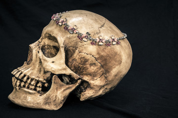 Still life with a human skull with the old, in with the diamond and jewelry