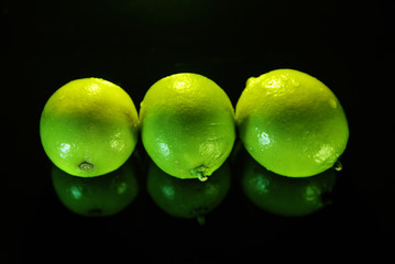 Three limes on a black background