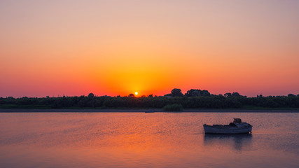 Amazing beautiful sunset on the river, evening time