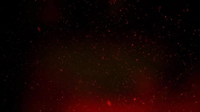 Burning sparks and ashes rise from the fire into the night sky. Looped video