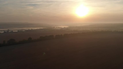 Dawn in the field. Fog over the field.