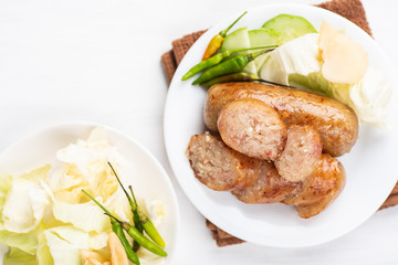 Thai sausage, fermented rice with pork sausage served with vegetables, top view
