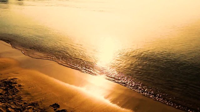 Sunset over the water on the beach.
