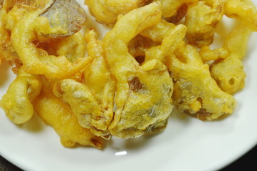 crispy batter-fried oyster mushroom with flour on white plate