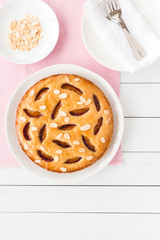 Victoria Plum Cake on White Wood Planks