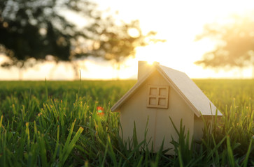 Image of vintage house in the grass, garden or park at sunset light.