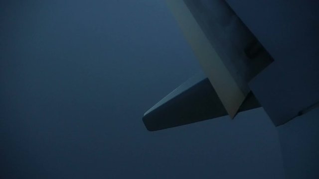 Plane wings and light in bad cloudy weather landing video