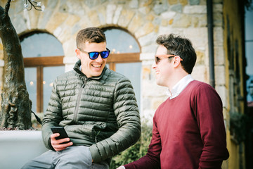 Two young friends chatting outdoors