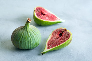 green figs on a gray stone background, concept, copy space