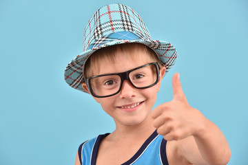 A boy with glasses. Isolated young man in a hat.