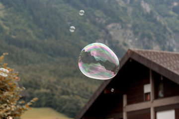 Big soap bubble flying through the air in the mountains