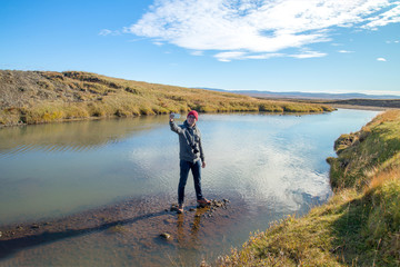 A tourist enjoy the view and take selfie in the river Olfusa near Gullfossfall , Iceland - 217907155