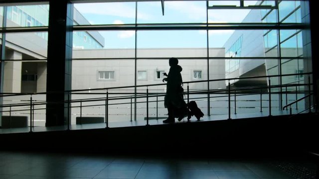 Silhouette of two walking girls in Muslim clothes to the left